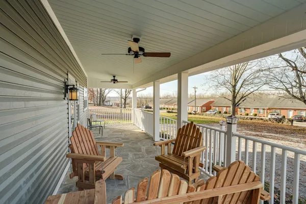 a view of a porch with furniture and wooden deck