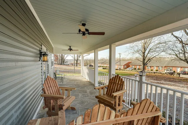 a view of a porch with furniture and wooden deck