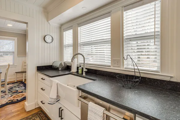 a kitchen with a sink a window and cabinets