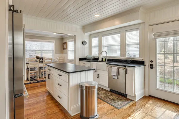 a kitchen with granite countertop a sink stove and cabinets