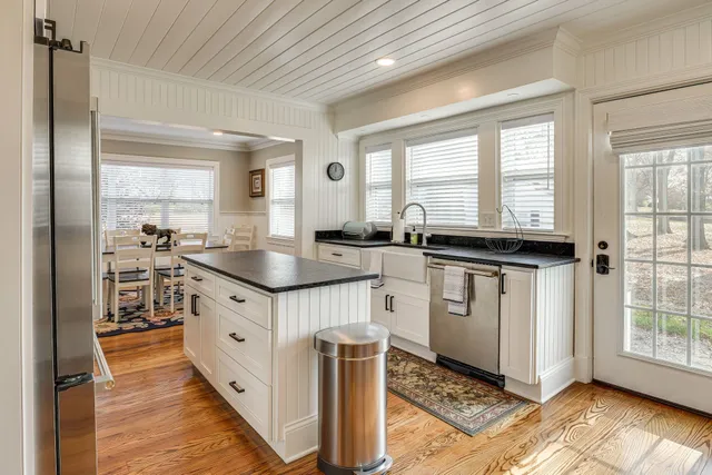 a kitchen with granite countertop a sink stove and cabinets