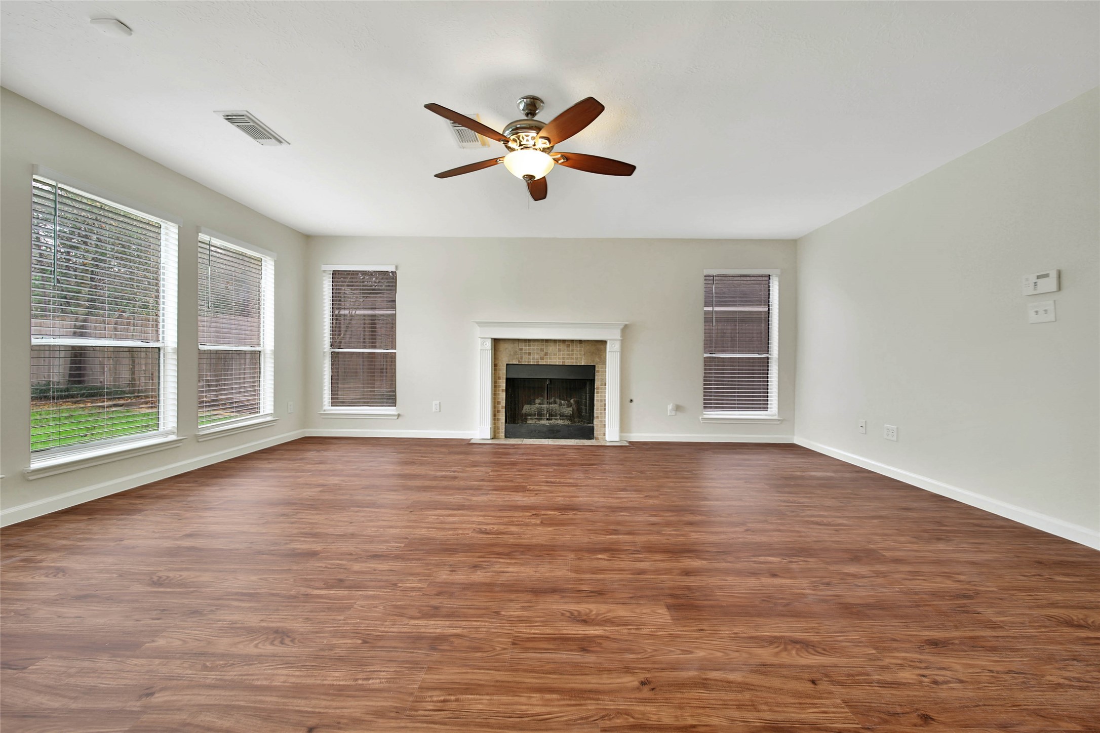 1427 Redwood Village Circle Spring, TX 77386 - Photo 11 of 43 a view of an empty room with wooden floor and a window