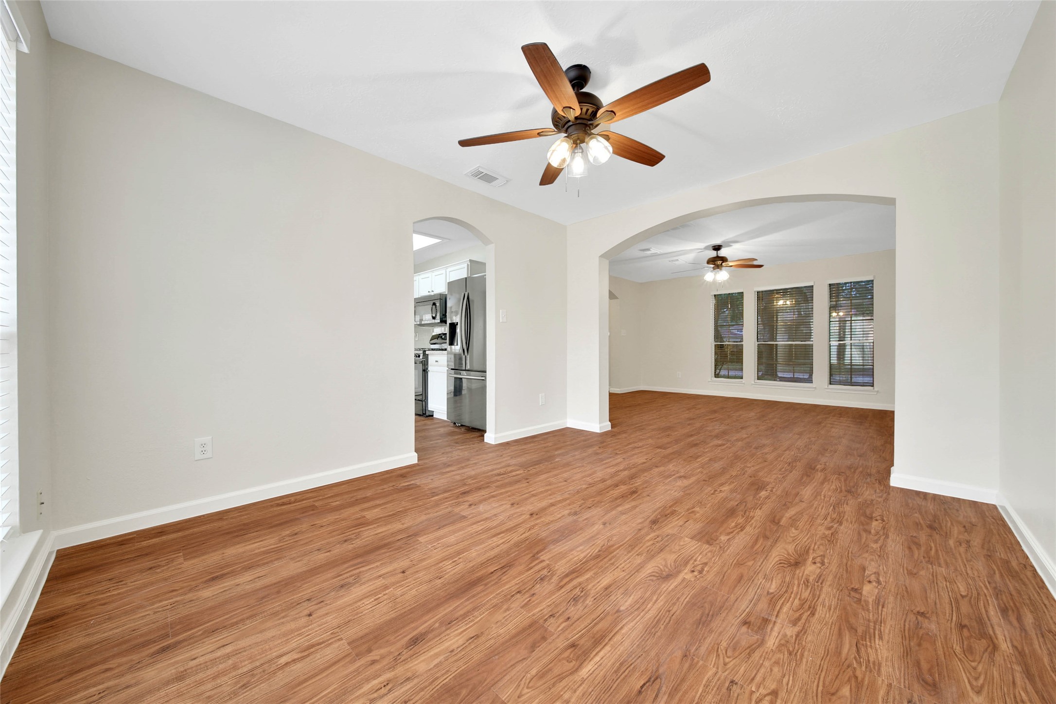 1427 Redwood Village Circle Spring, TX 77386 - Photo 12 of 43 a view of an empty room with wooden floor and a window