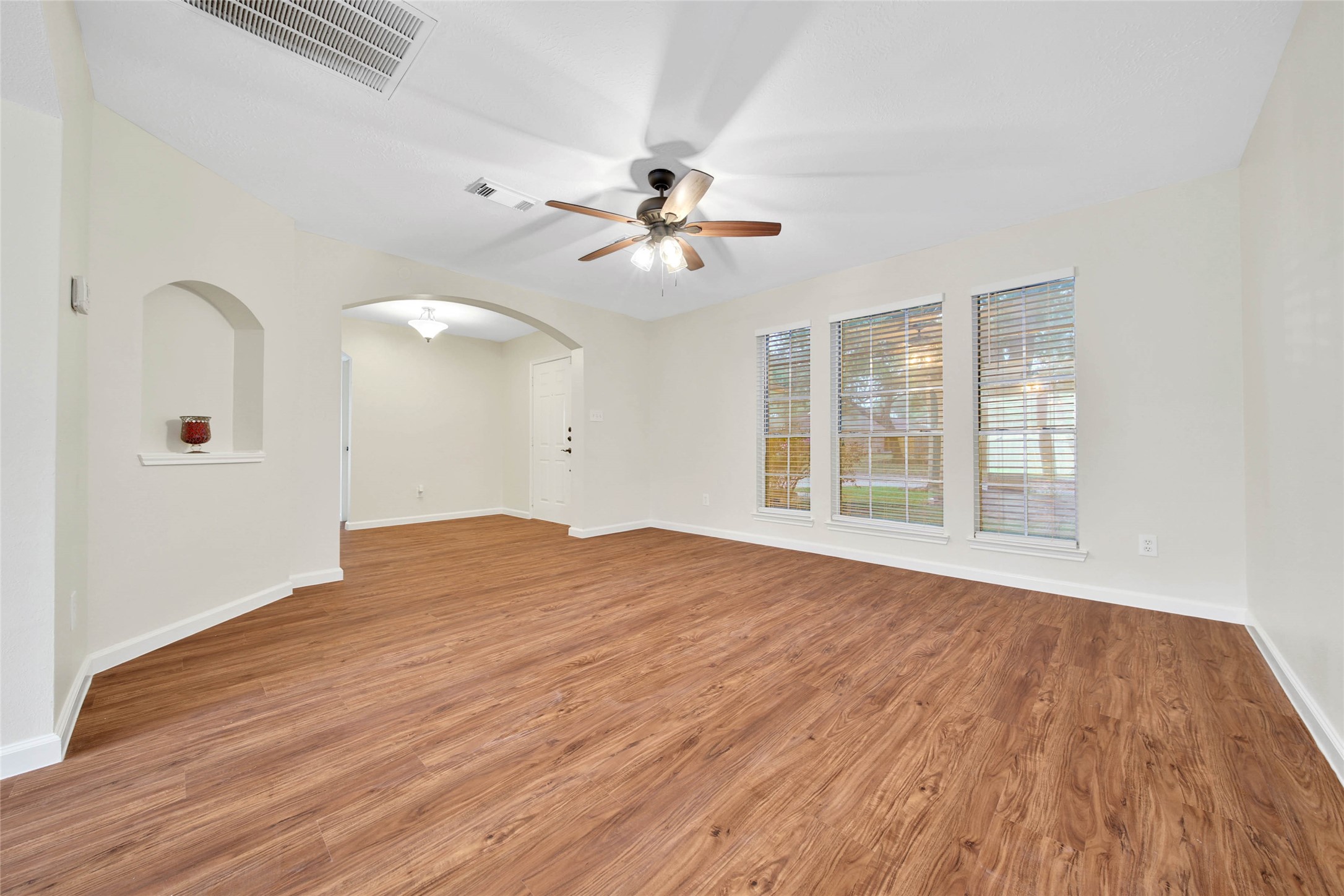 1427 Redwood Village Circle Spring, TX 77386 - Photo 14 of 43 a view of empty room with wooden floor and fan