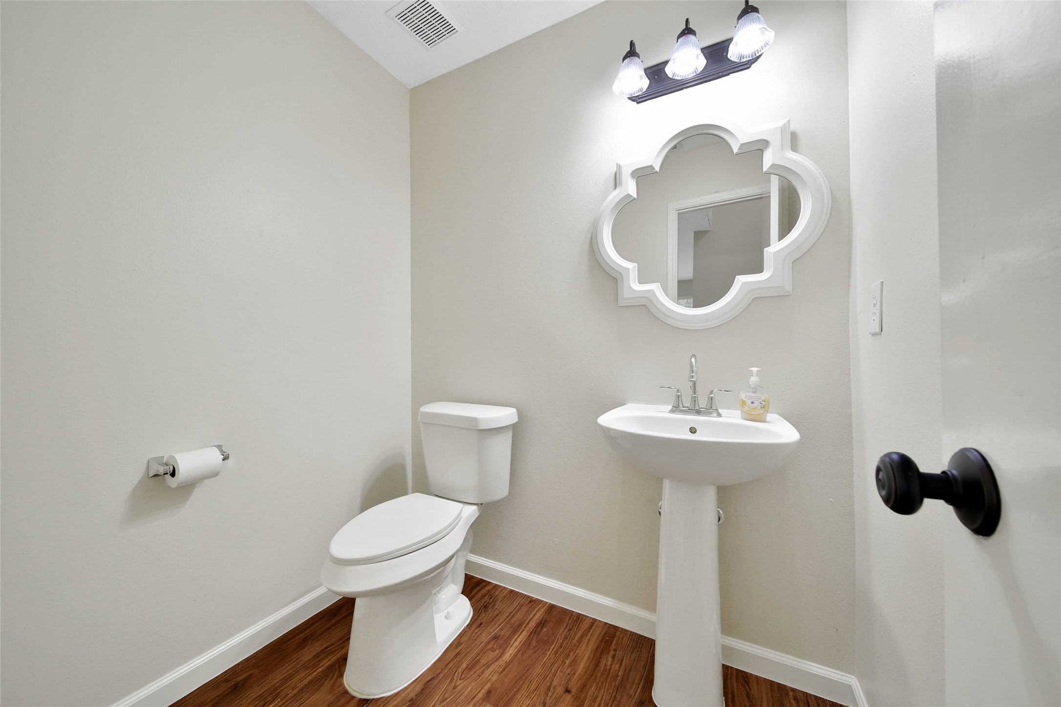 1427 Redwood Village Circle Spring, TX 77386 - Photo 16 of 43 a bathroom with a toilet sink and mirror