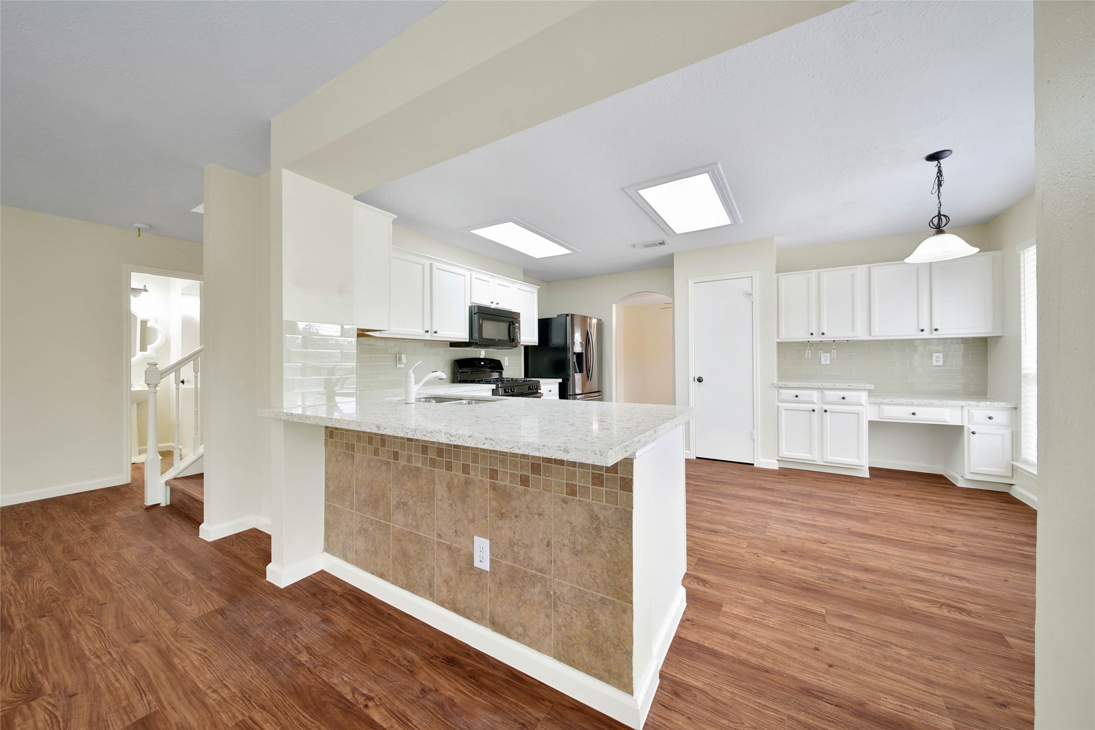 1427 Redwood Village Circle Spring, TX 77386 - Photo 21 of 43 a large kitchen with cabinets and wooden floor