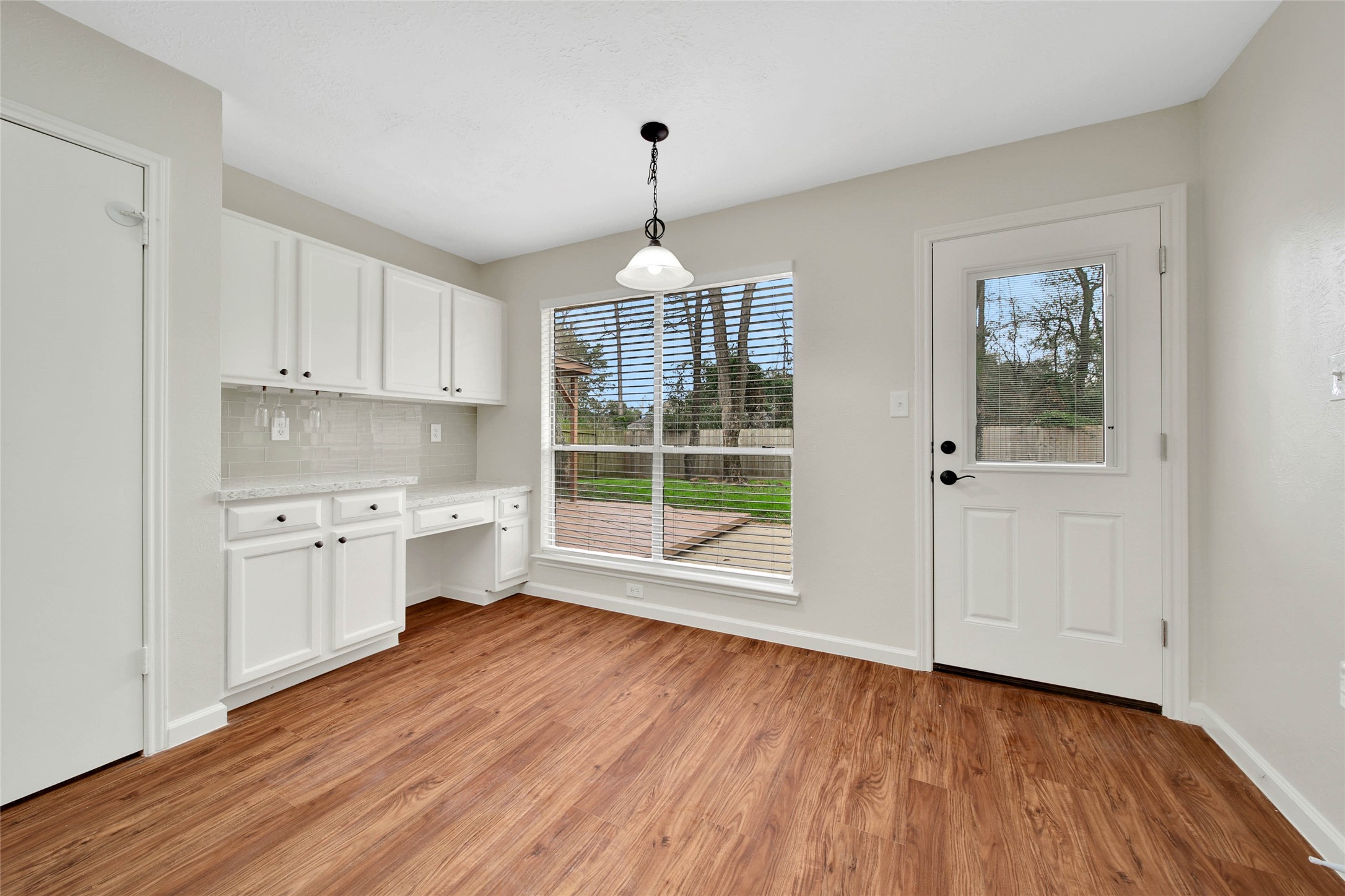 1427 Redwood Village Circle Spring, TX 77386 - Photo 22 of 43 a room with wooden floors and white walls