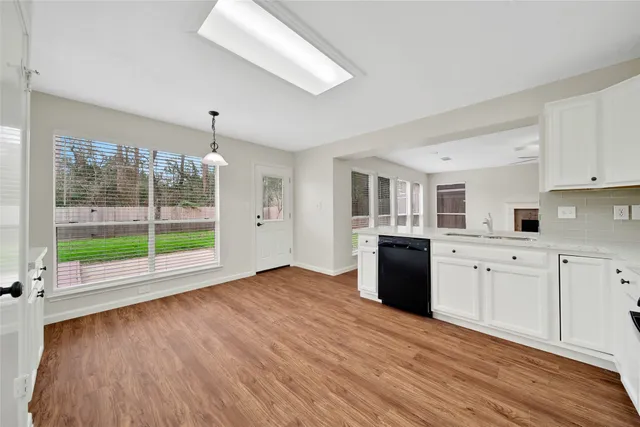 a kitchen with a refrigerator and a stove top oven