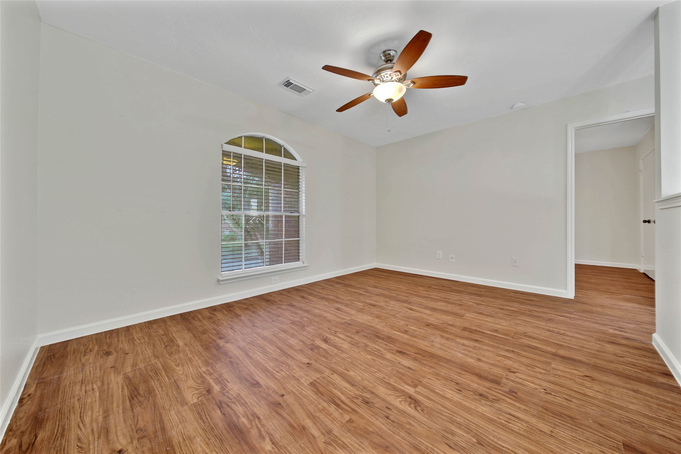 1427 Redwood Village Circle Spring, TX 77386 - Photo 27 of 43 a view of an empty room with wooden floor and a window