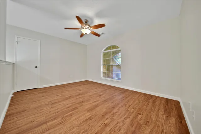 wooden floor in an empty room with a window