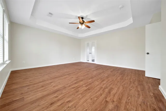 wooden floor in an empty room with a window
