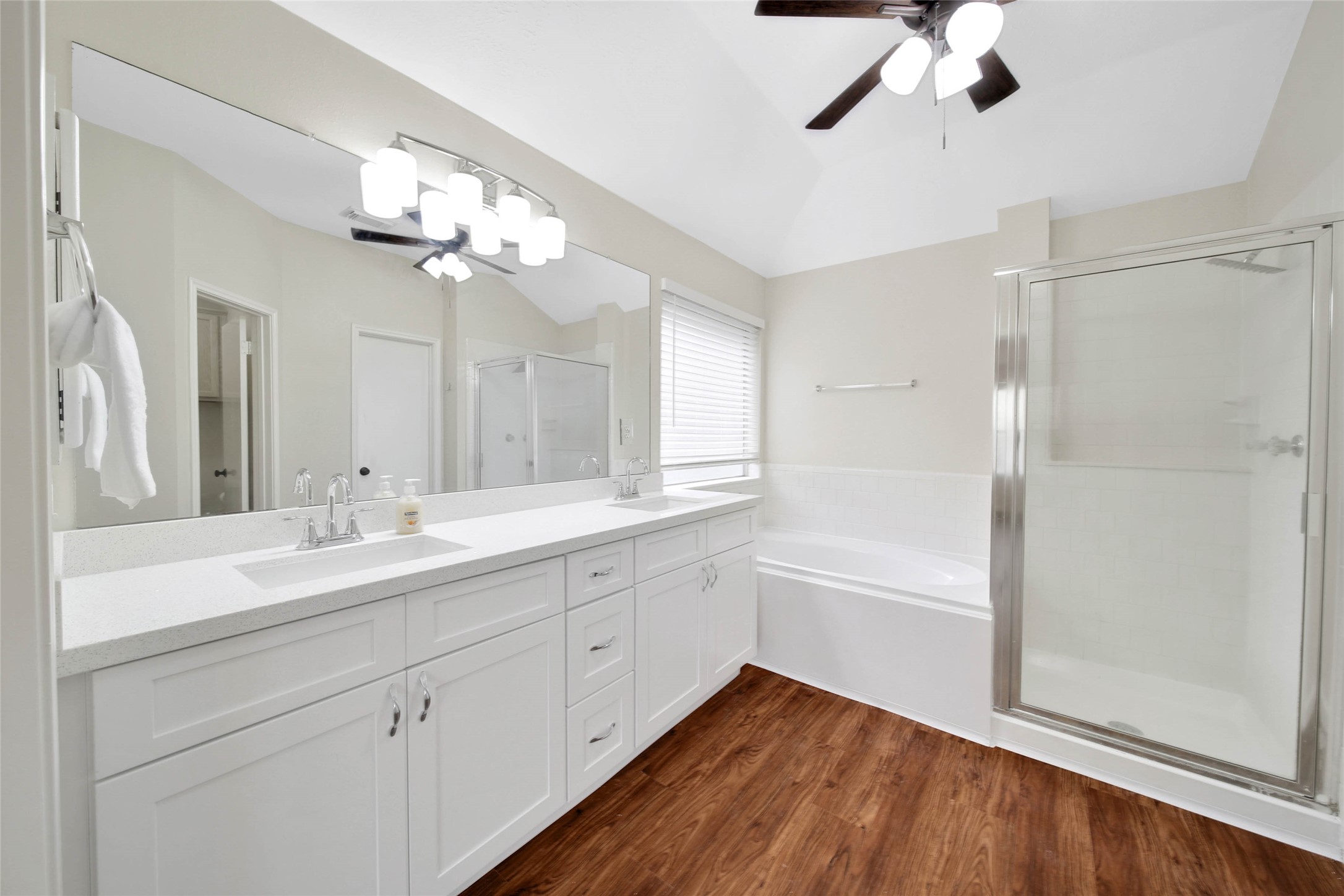 1427 Redwood Village Circle Spring, TX 77386 - Photo 35 of 43 a bathroom with a double vanity sink a mirror and a bathtub