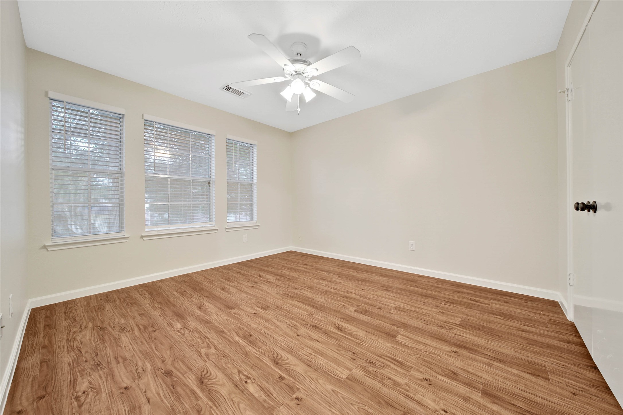 1427 Redwood Village Circle Spring, TX 77386 - Photo 41 of 43 a view of an empty room with wooden floor and a window