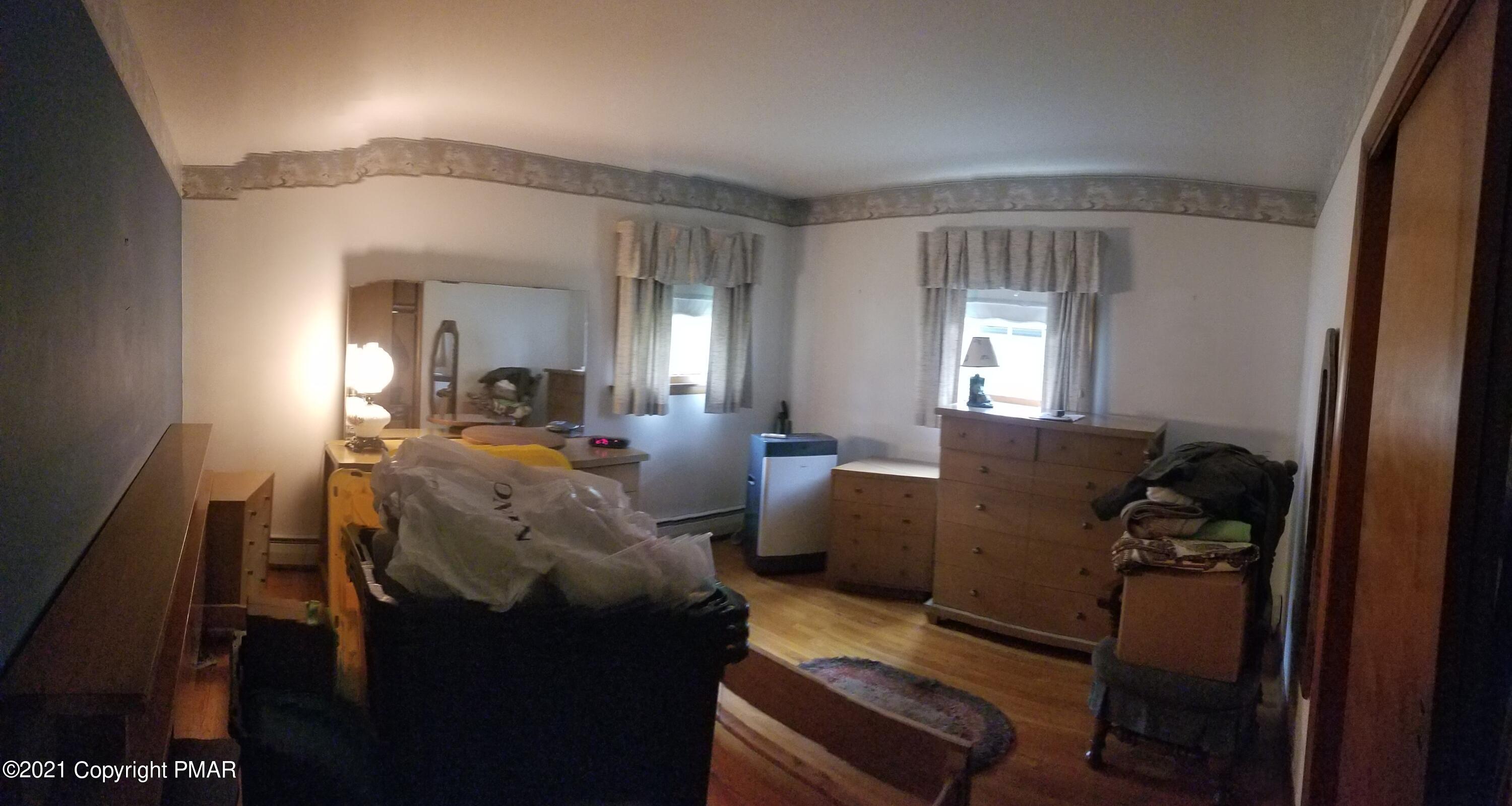 1111 Hillcrest Drive Stroudsburg, PA 18360 - Photo 12 of 20 a living room with furniture and a mirror