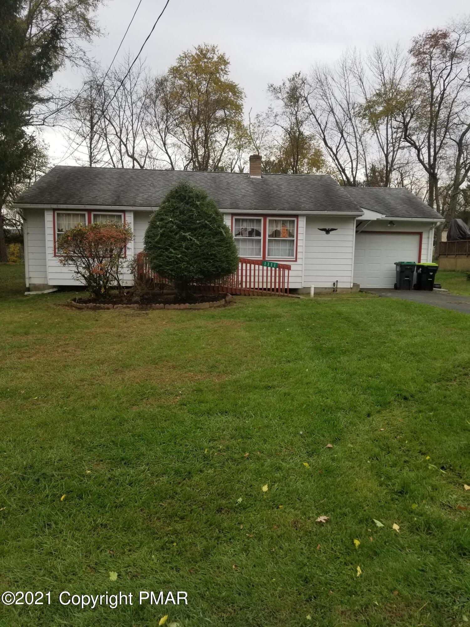 1111 Hillcrest Drive Stroudsburg, PA 18360 - Photo 3 of 20 a front view of a house with garden