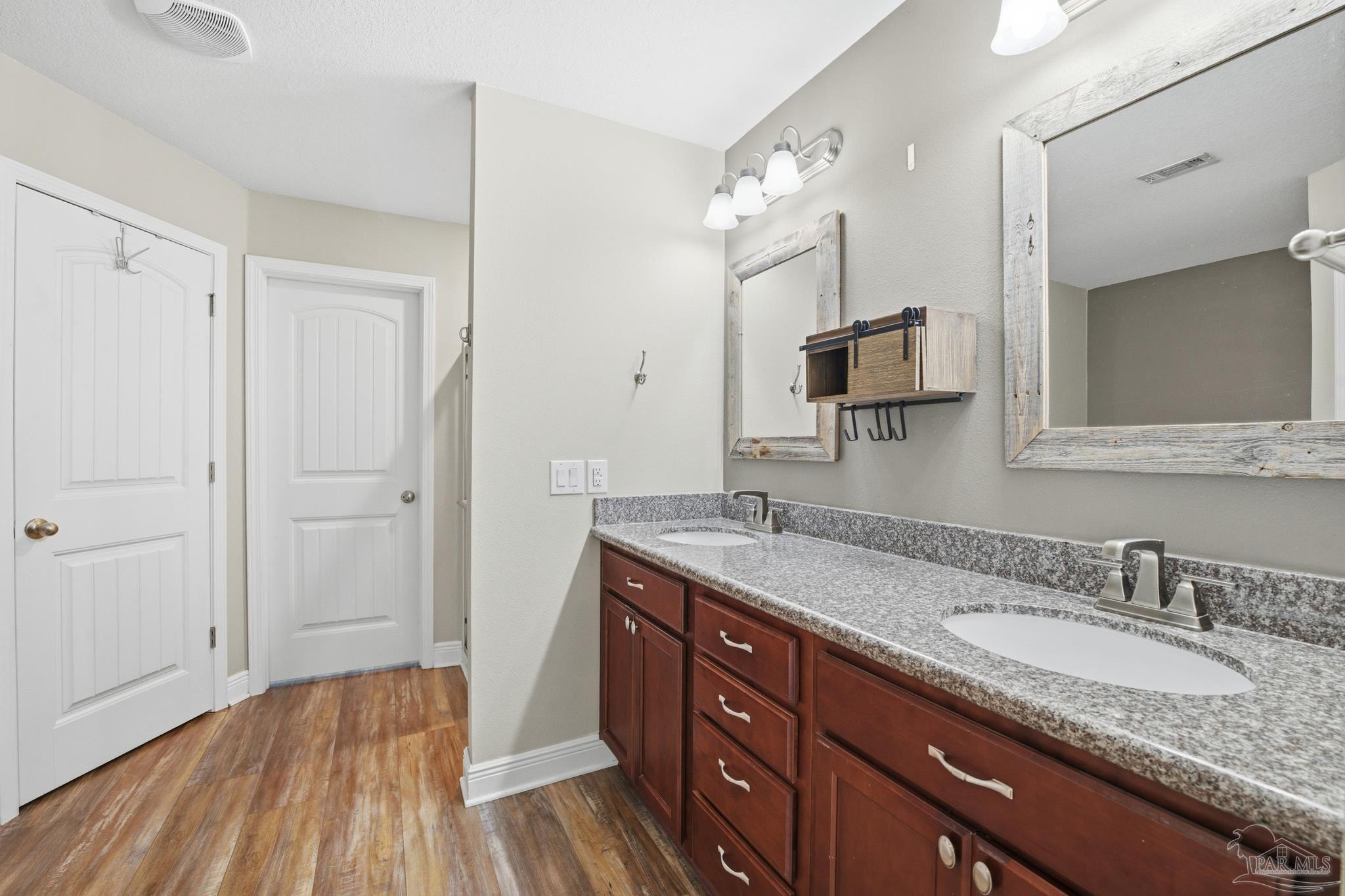 5661 Cane Syrup Circle Pace, FL 32571 - Photo 10 of 20 a bathroom with a granite countertop double vanity sink and mirror