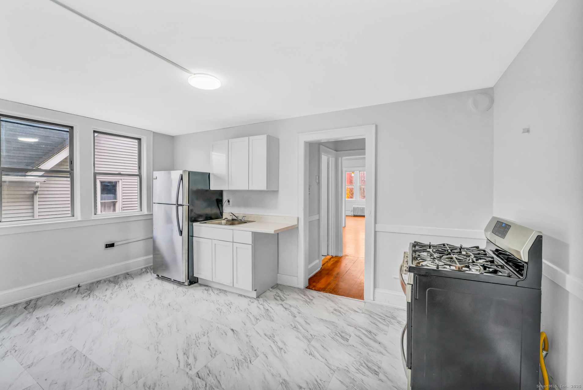 1040 Capitol Avenue, Unit 2E Hartford, CT 06106 - Photo 1 of 5 a kitchen with stainless steel appliances kitchen island granite countertop a refrigerator stove top oven and sink