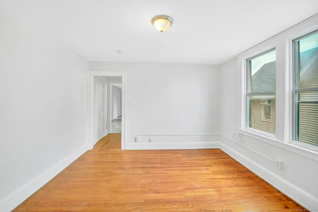 a view of empty room with window and floor to ceiling window