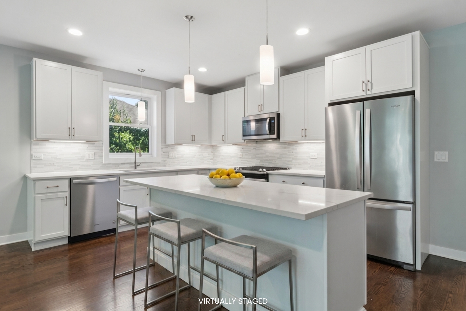4845 North Keystone Avenue, Unit 2N Chicago, IL 60630 - Photo 4 of 21 a kitchen with stainless steel appliances granite countertop a sink a stove a refrigerator and island with wooden floor