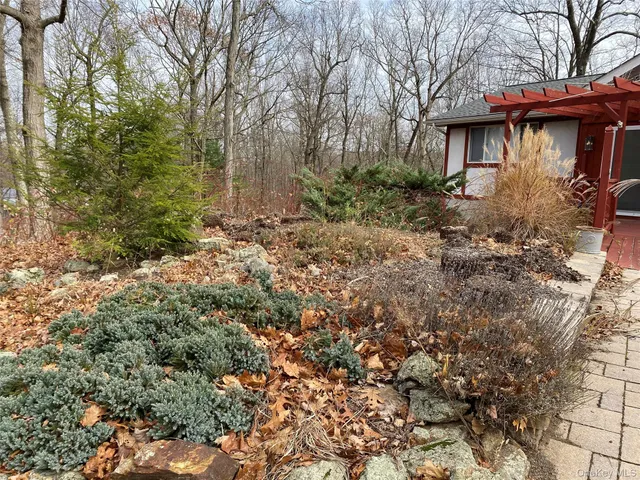 a view of a wooden house with a yard