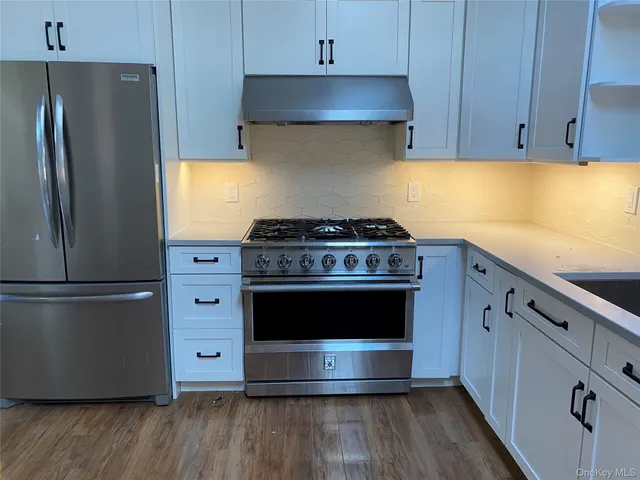 a kitchen with a stove and a refrigerator
