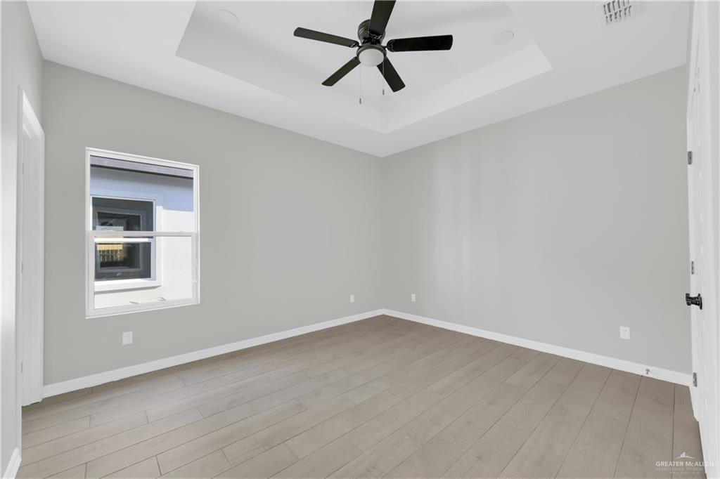 909 East 13th Street, Unit 4 San Juan, TX 78589 - Photo 11 of 14 an empty room with a window and ceiling fan