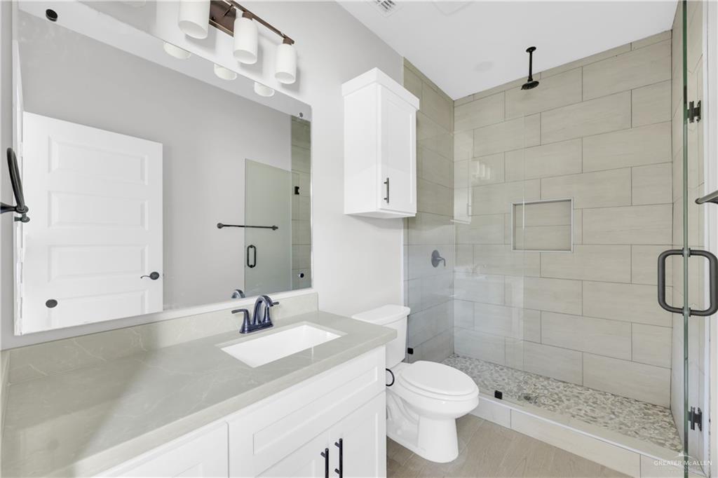 909 East 13th Street, Unit 4 San Juan, TX 78589 - Photo 12 of 14 a bathroom with a sink a toilet and shower