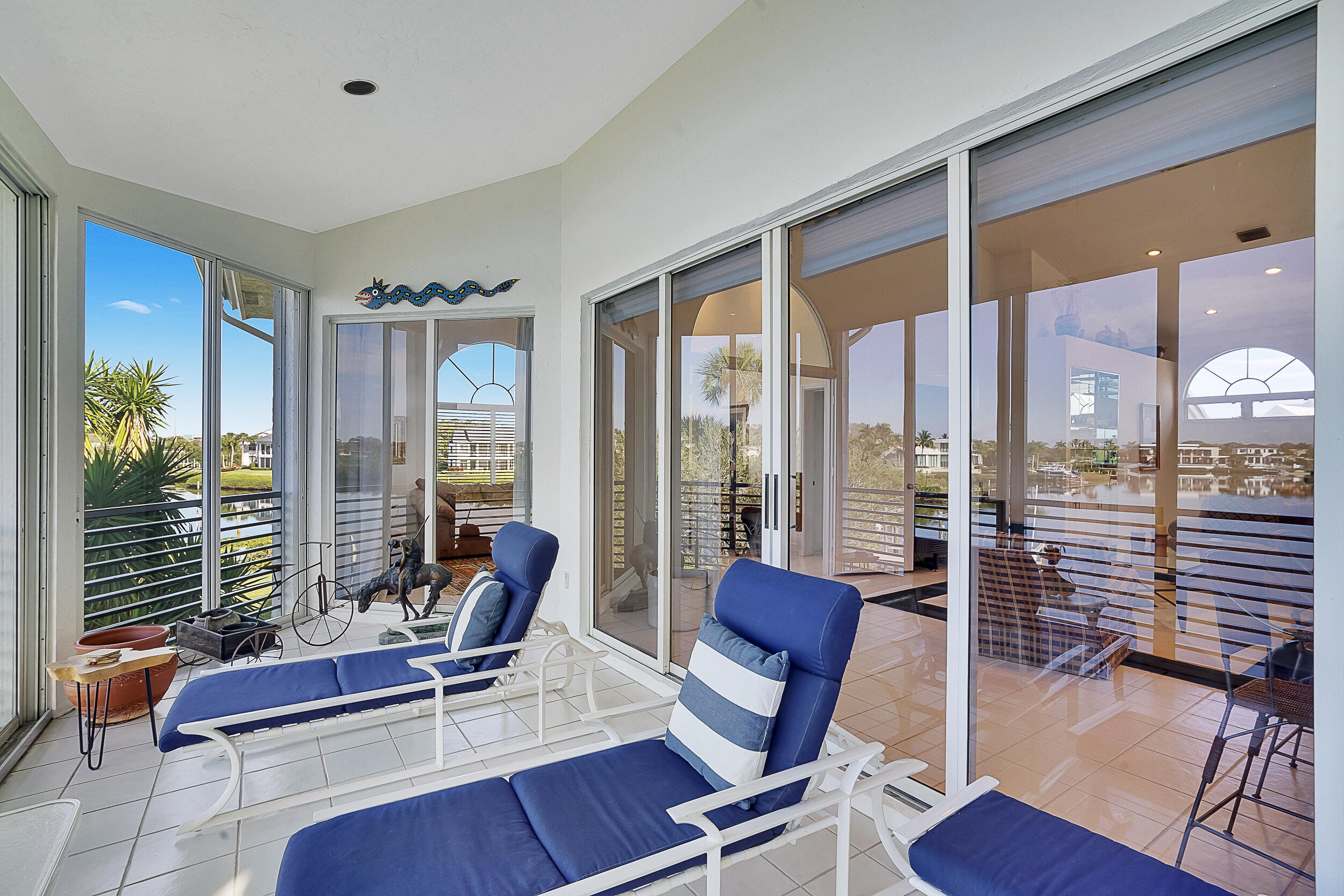 2703 Captains Way Jupiter, FL 33477 - Photo 13 of 57 a living room with furniture and a floor to ceiling window