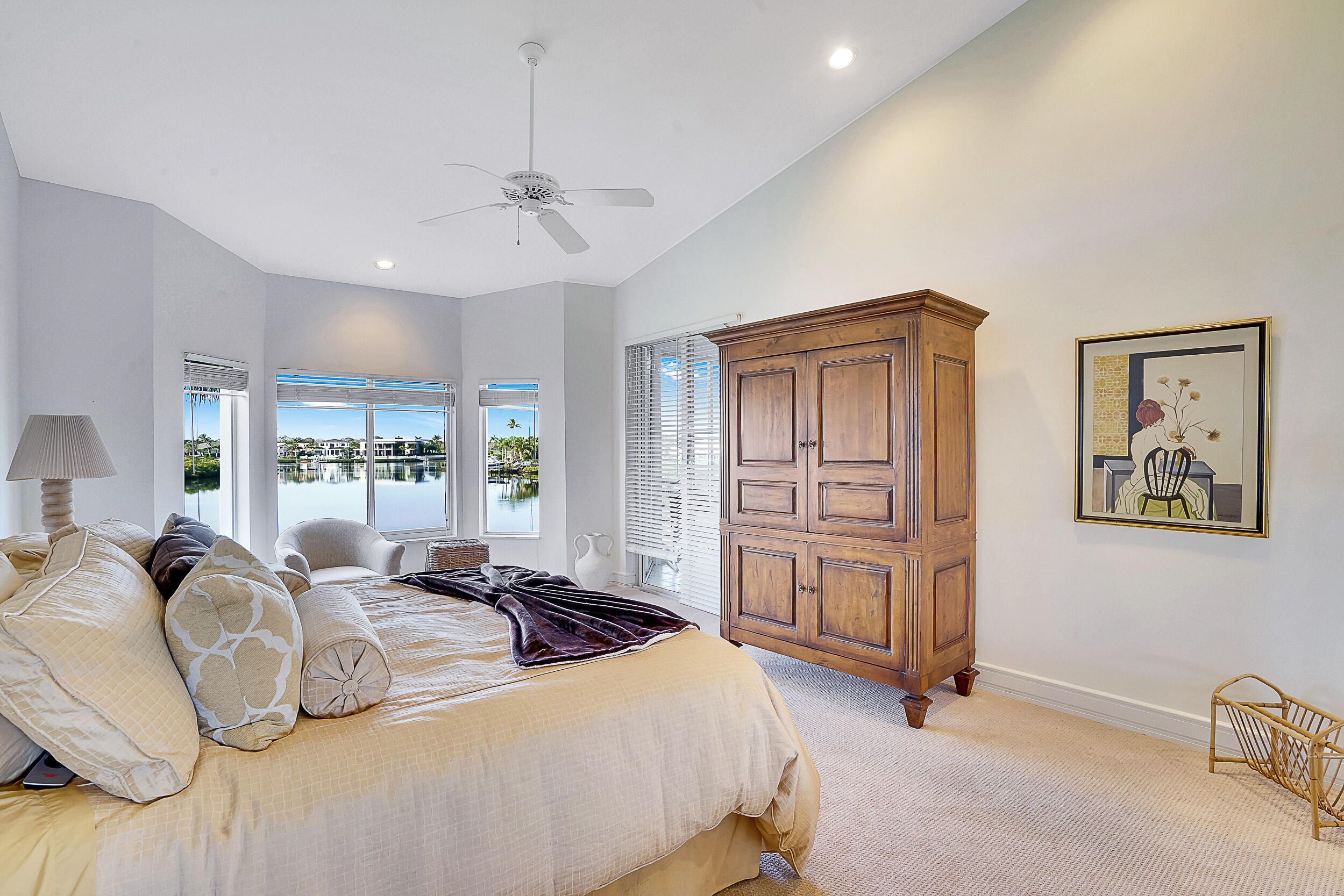 2703 Captains Way Jupiter, FL 33477 - Photo 19 of 57 a bedroom with a bed dresser and wooden floor