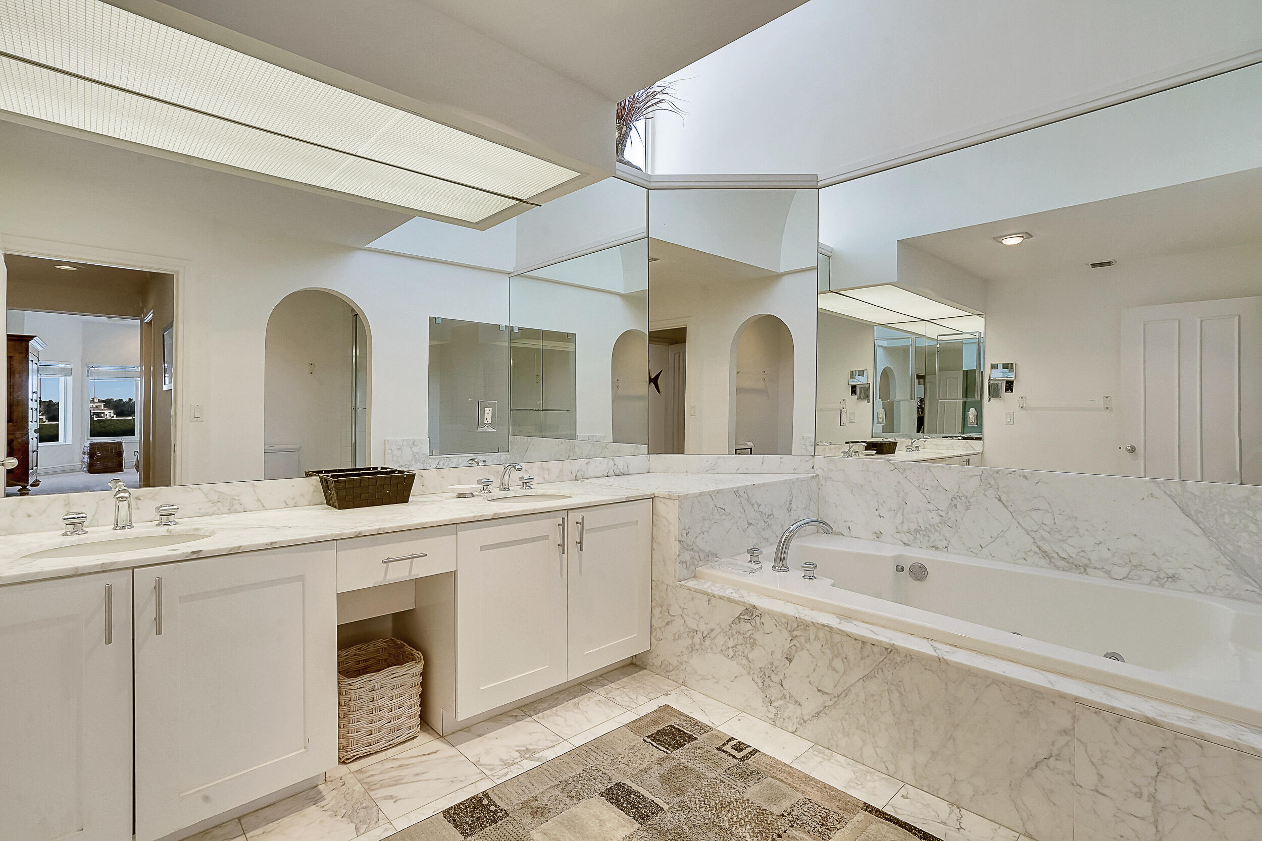 2703 Captains Way Jupiter, FL 33477 - Photo 21 of 57 a spacious bathroom with a granite countertop sink mirror and bathtub
