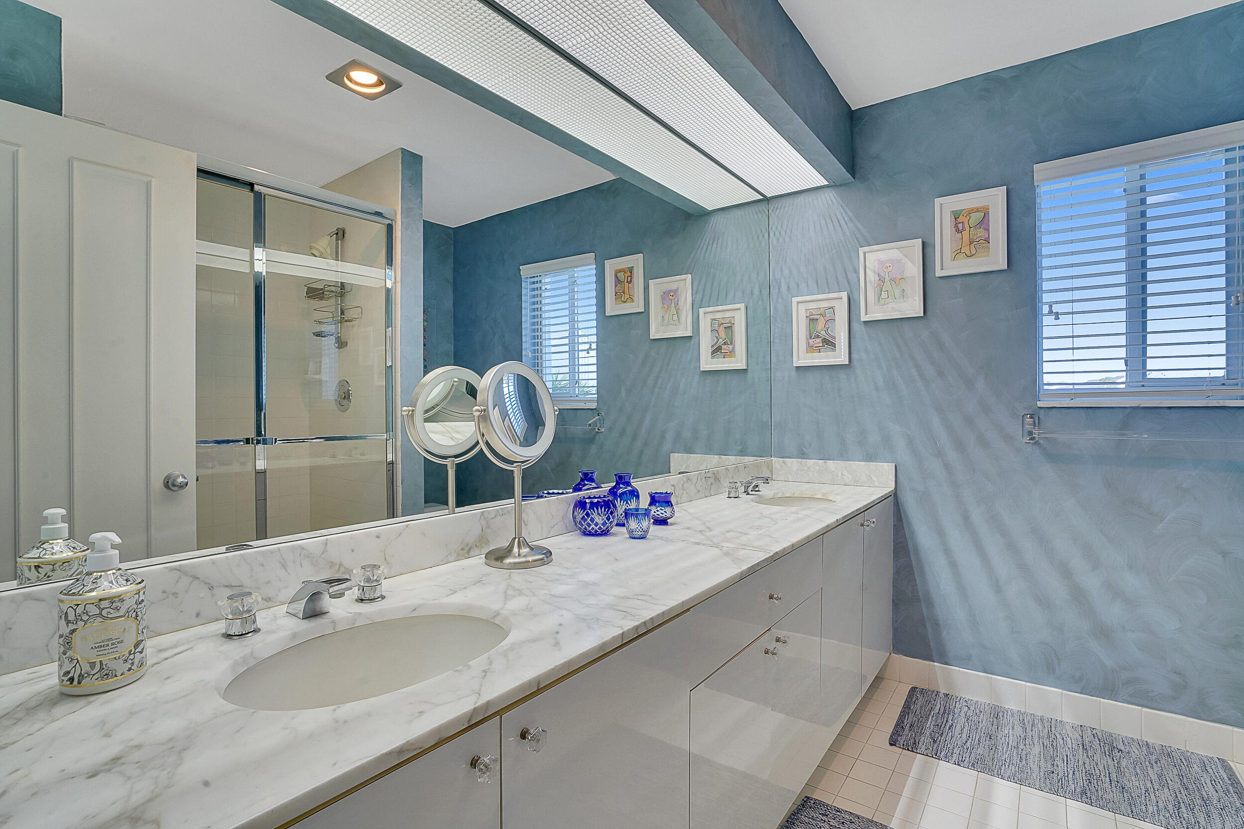 2703 Captains Way Jupiter, FL 33477 - Photo 24 of 57 a bathroom with a granite countertop sink and a mirror