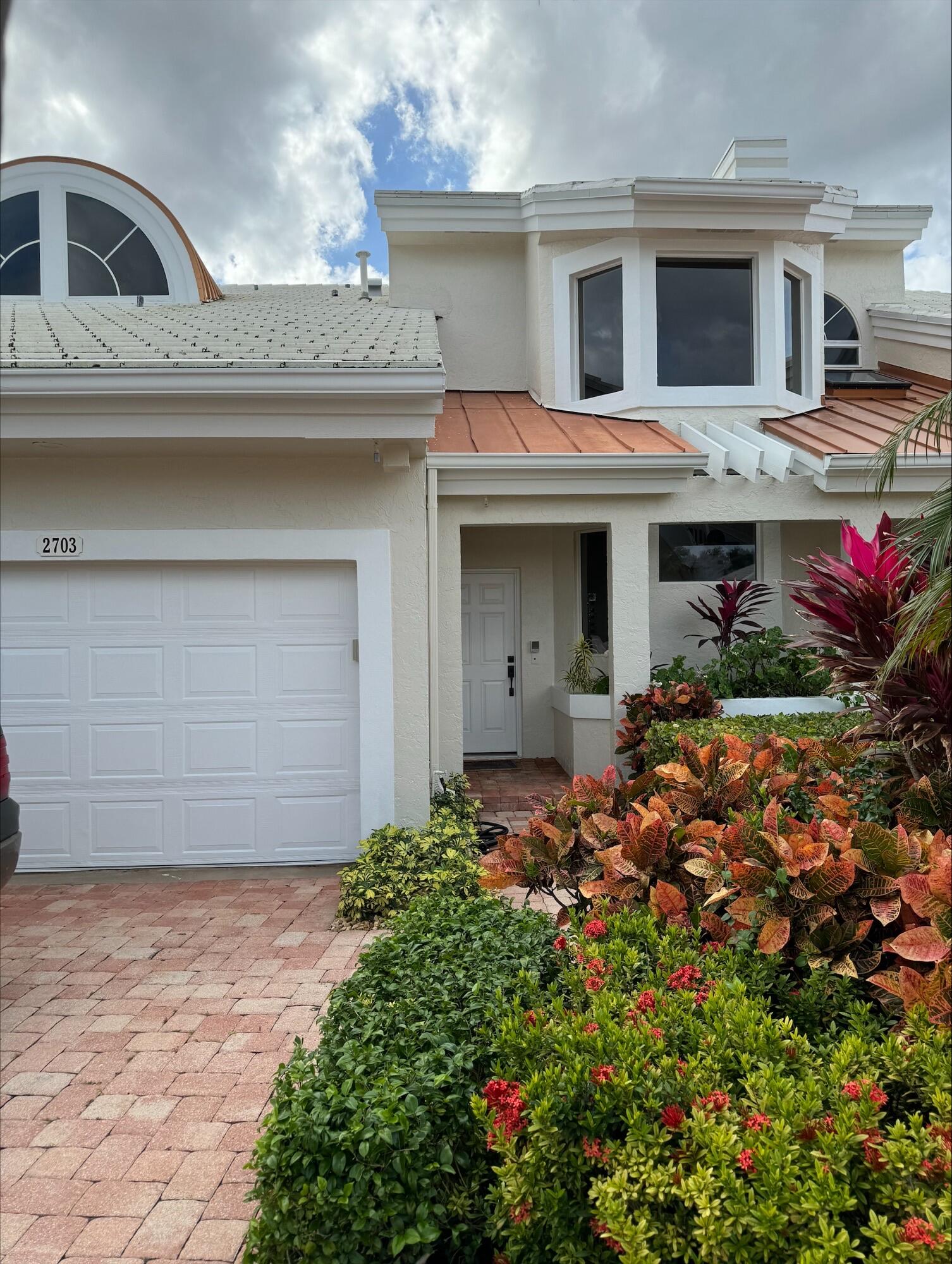 2703 Captains Way Jupiter, FL 33477 - Photo 30 of 57 a view of a house with a garden