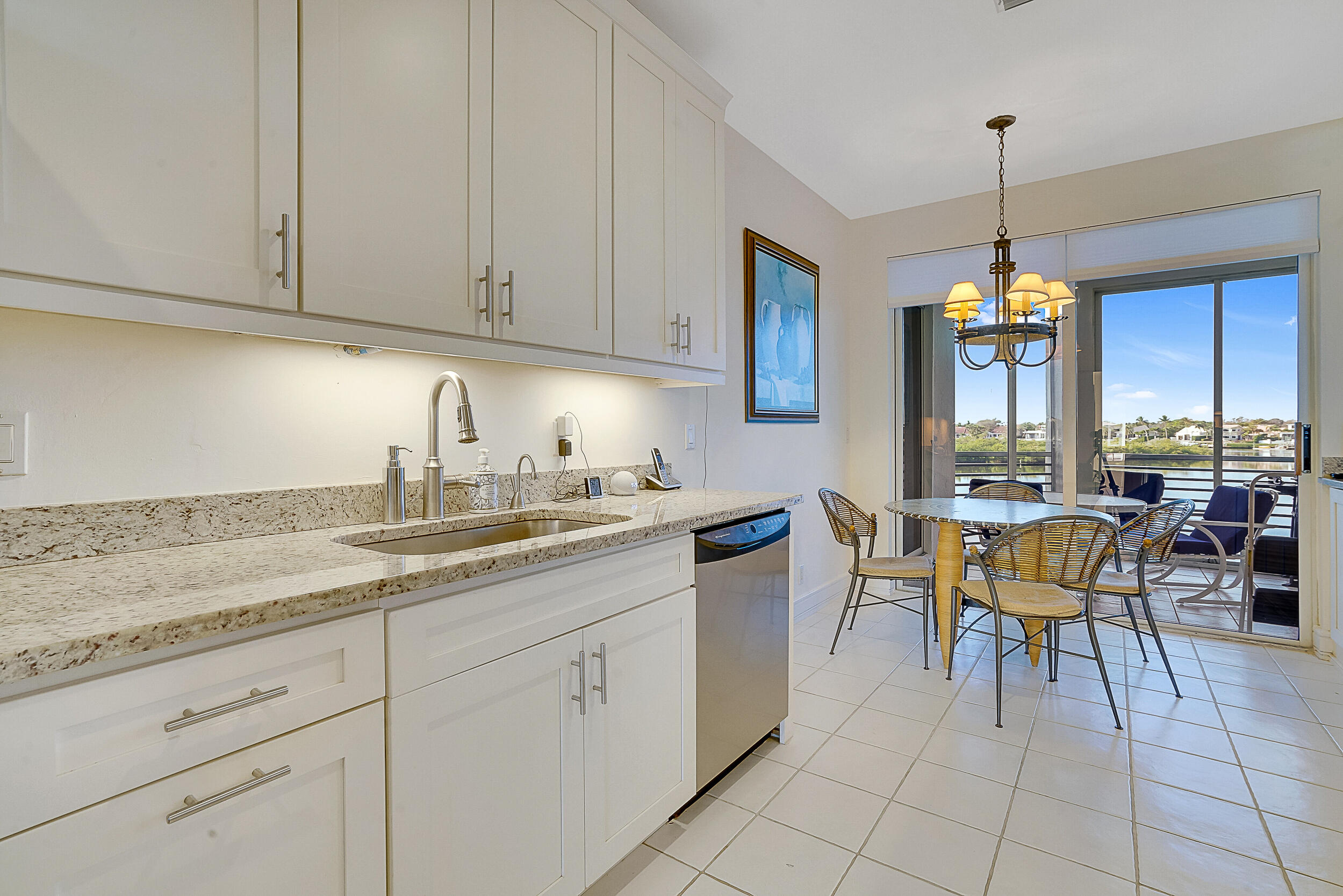 2703 Captains Way Jupiter, FL 33477 - Photo 8 of 57 a kitchen with cabinets appliances and a center island