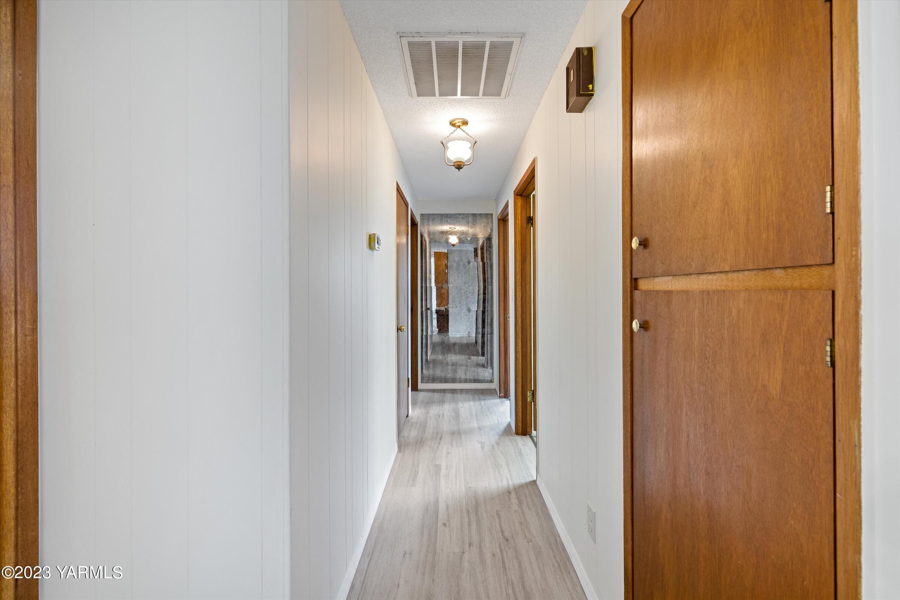 2901 Jones Road Wapato, WA 98951 - Photo 23 of 32 a view of a hallway with wooden floor
