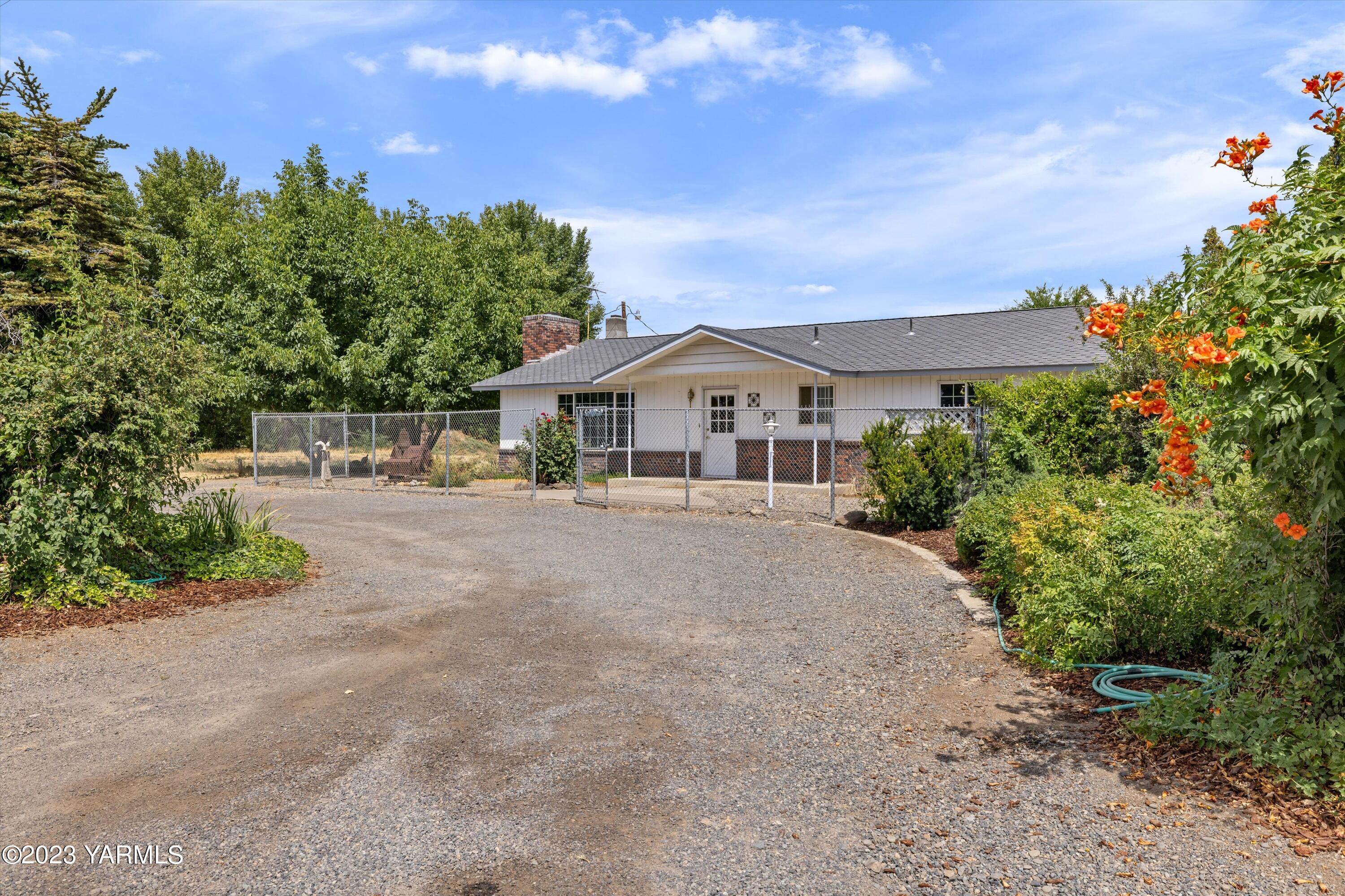 2901 Jones Road Wapato, WA 98951 - Photo 3 of 32 a house with trees in the background