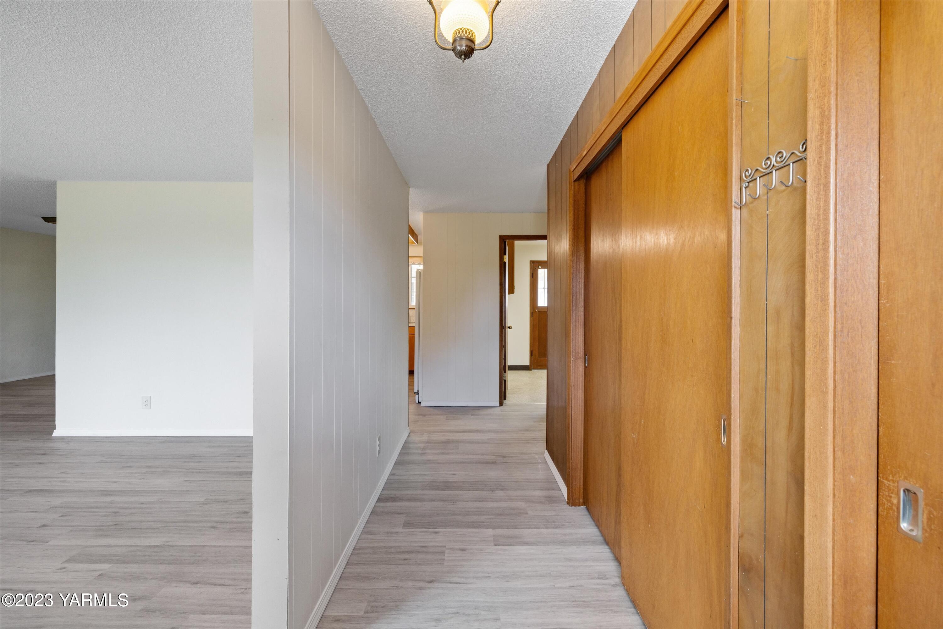 2901 Jones Road Wapato, WA 98951 - Photo 5 of 32 a view of a hallway with wooden floor