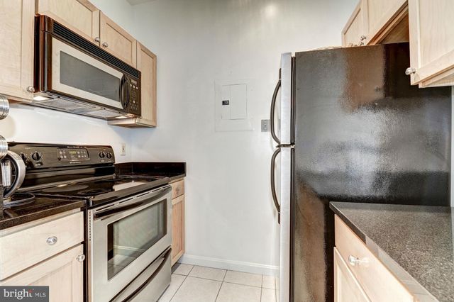 a kitchen with stainless steel appliances granite countertop a stove microwave and refrigerator