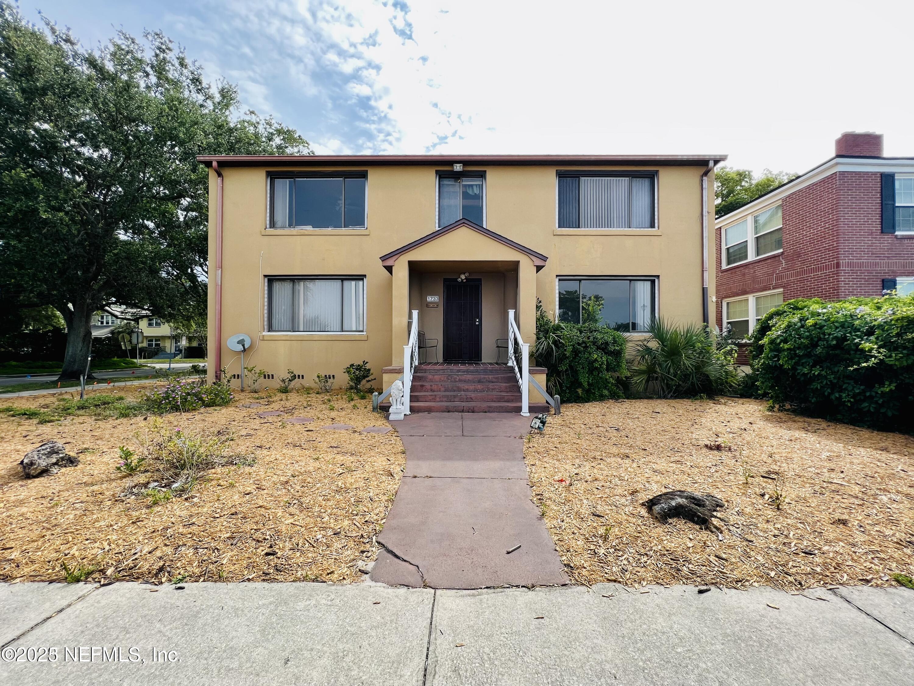 a front view of a house with garden