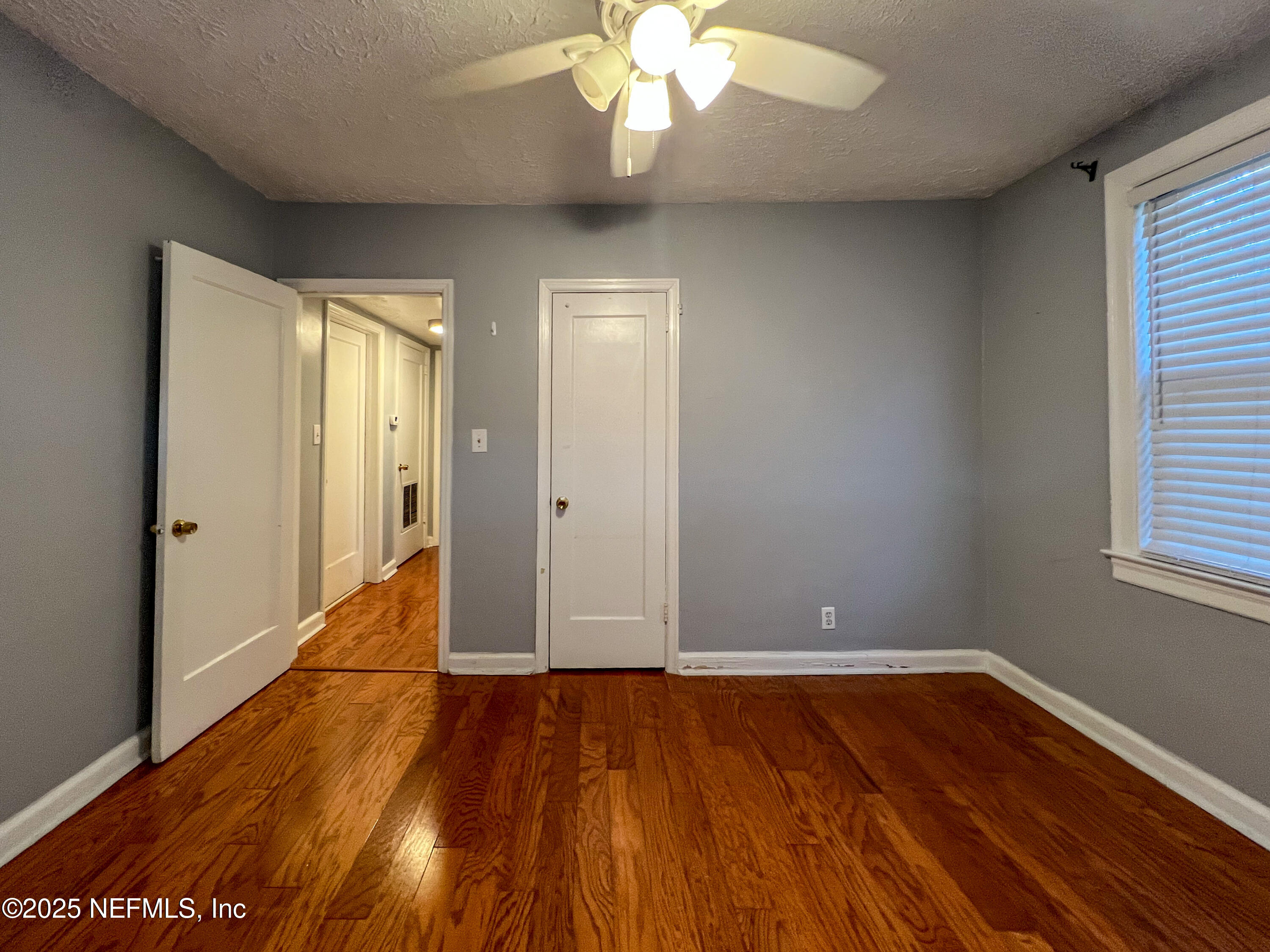 1733 River Road, Unit 1 Jacksonville, FL 32207 - Photo 12 of 16 wooden floor in an empty room with a window