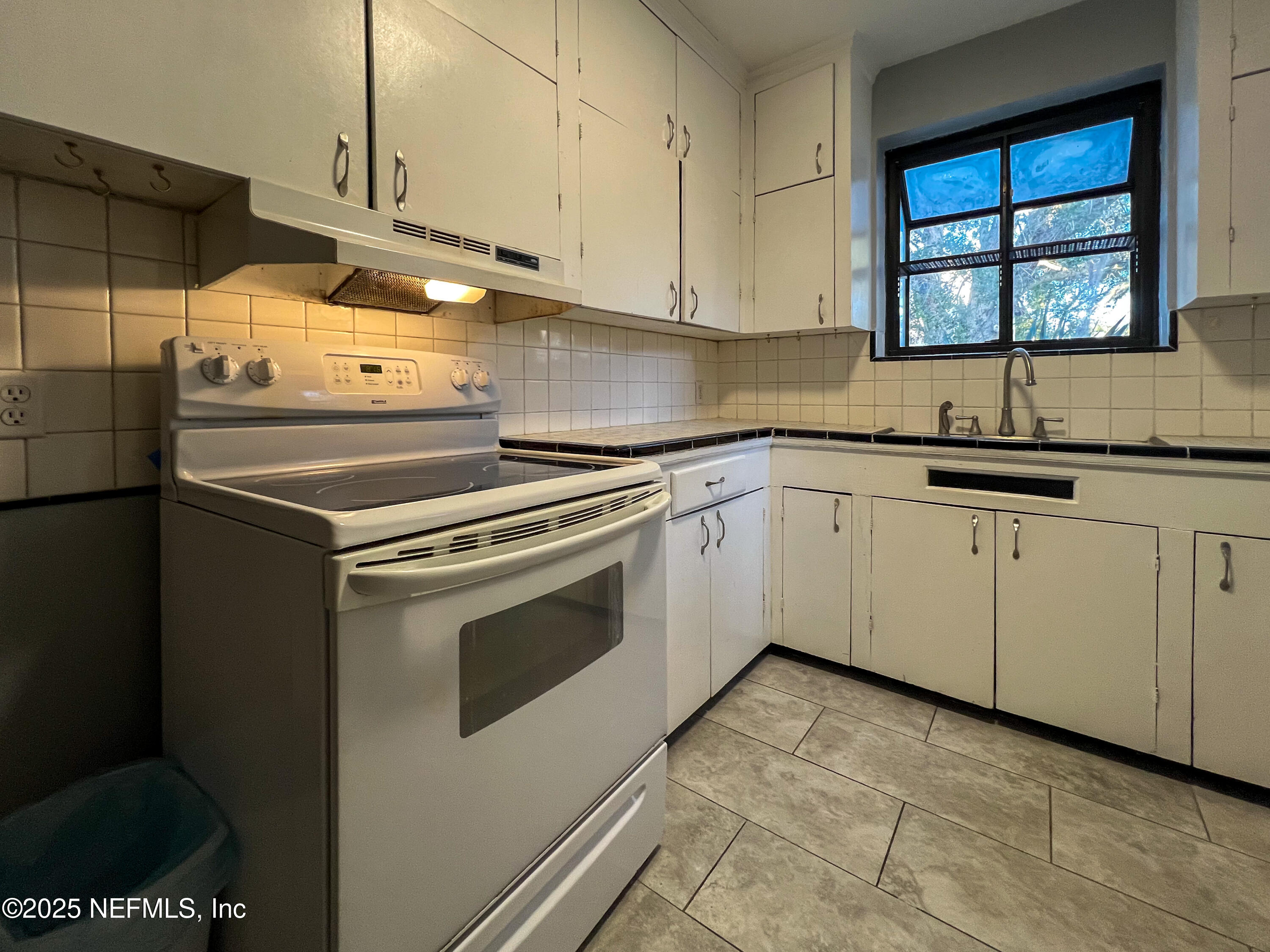 1733 River Road, Unit 1 Jacksonville, FL 32207 - Photo 7 of 16 a kitchen with granite countertop cabinets stainless steel appliances and a sink
