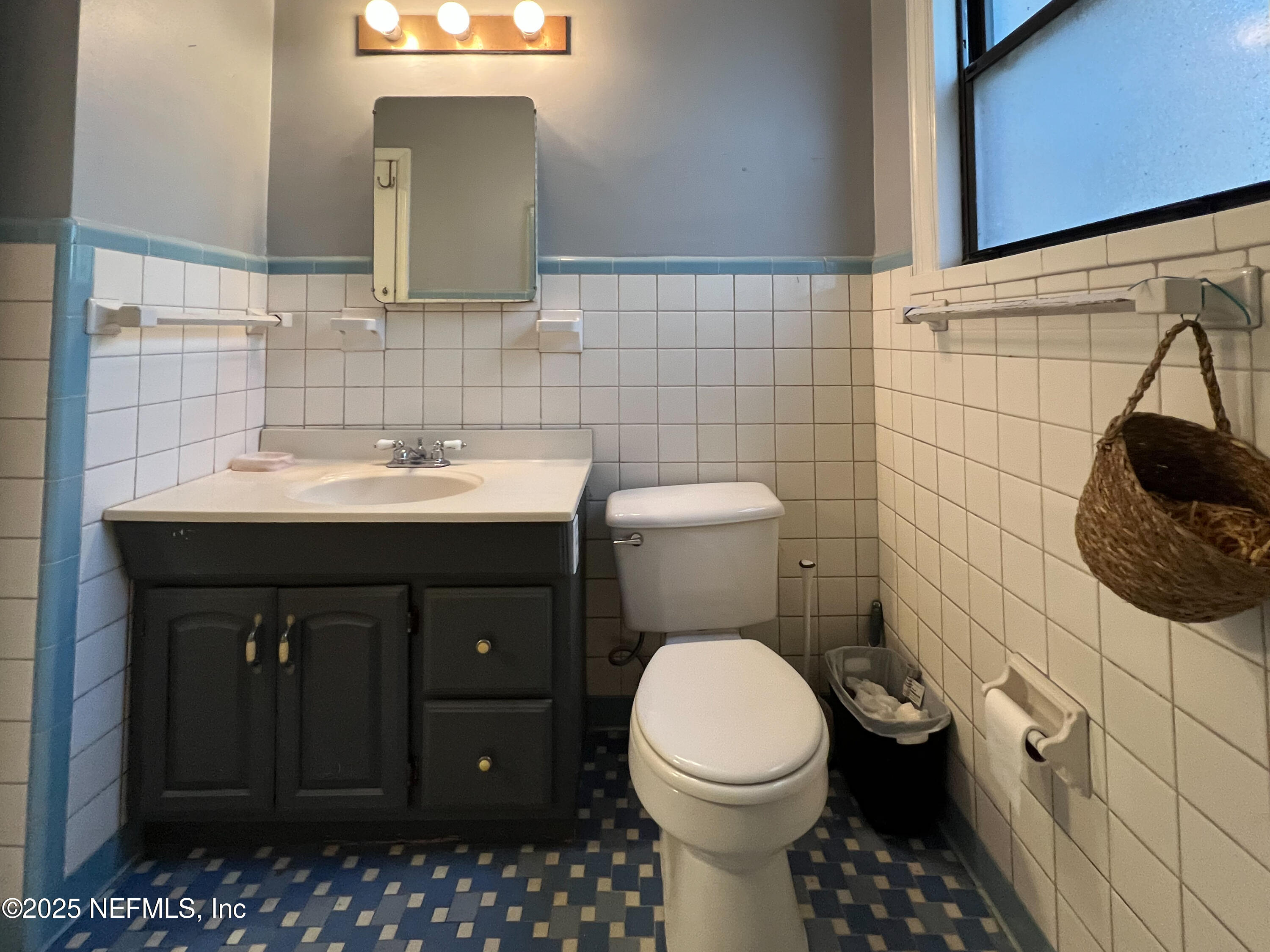 1733 River Road, Unit 1 Jacksonville, FL 32207 - Photo 10 of 16 a bathroom with a sink toilet and mirror