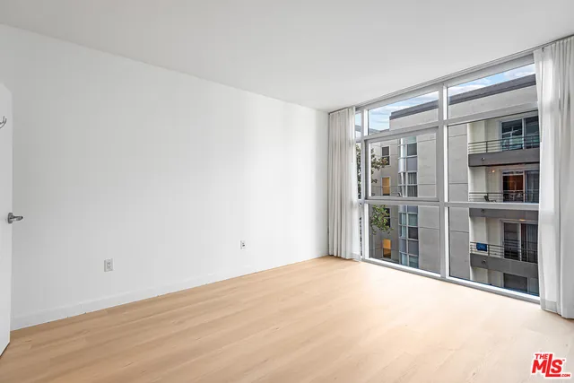 a spacious bathroom with a granite countertop sink mirror and shower