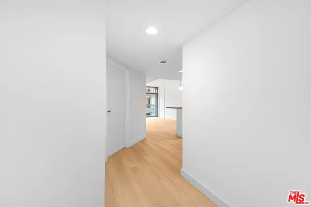a view of hallway with wooden floor