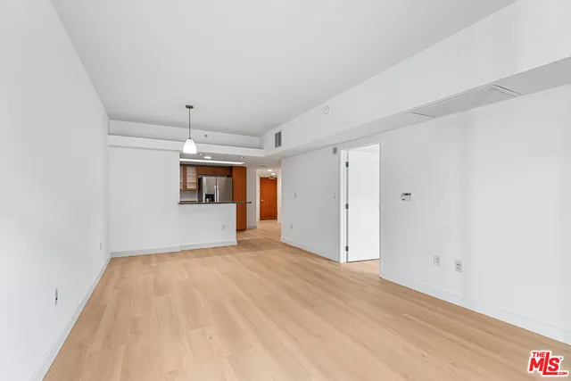 a view of a kitchen with a sink and a refrigerator