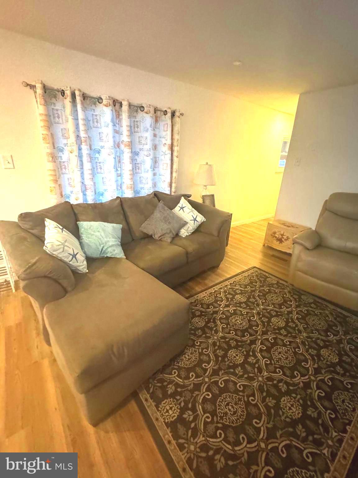 119 Clamshell Road Ocean City, MD 21842 - Photo 6 of 14 a living room with furniture and a floor to ceiling window