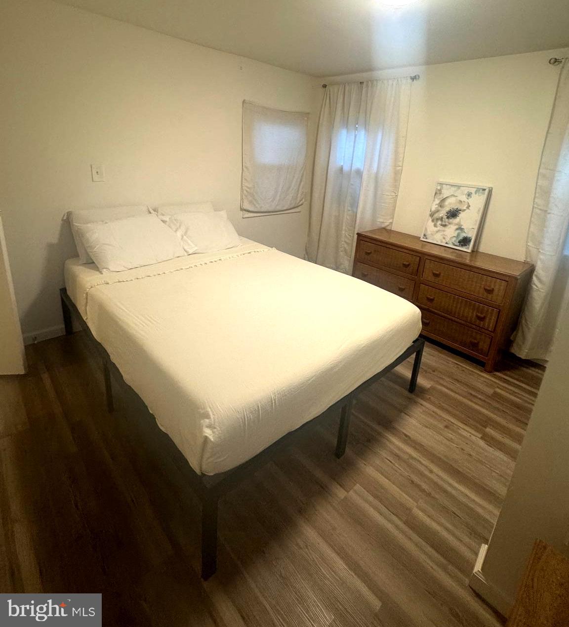 119 Clamshell Road Ocean City, MD 21842 - Photo 10 of 14 a bedroom with a bed and wooden floor