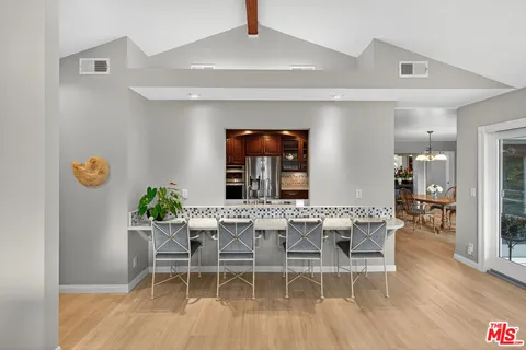 a dining room with furniture and wooden floor