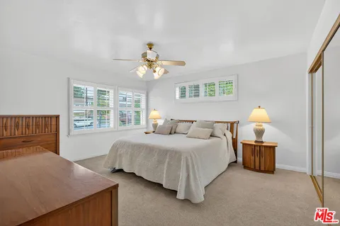 a bedroom with bed and window