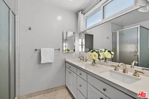 a bathroom with a double vanity sink and mirror