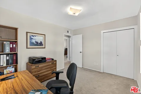 a bedroom with furniture and a book shelf